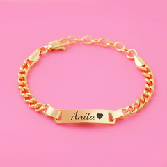 Gold bracelet with 'Anita' engraved on a pink background