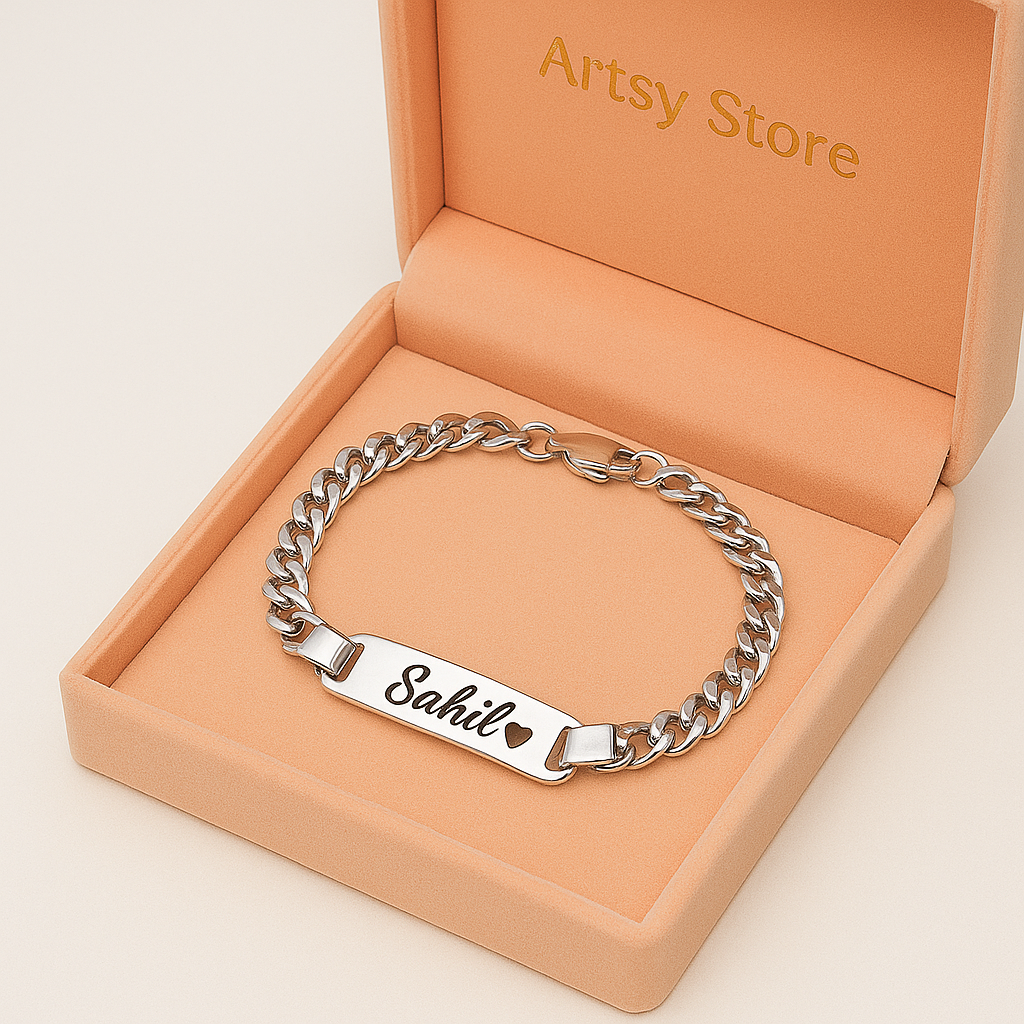 Silver chain bracelet with engraved name on a beige box labeled 'Artsy Store'.